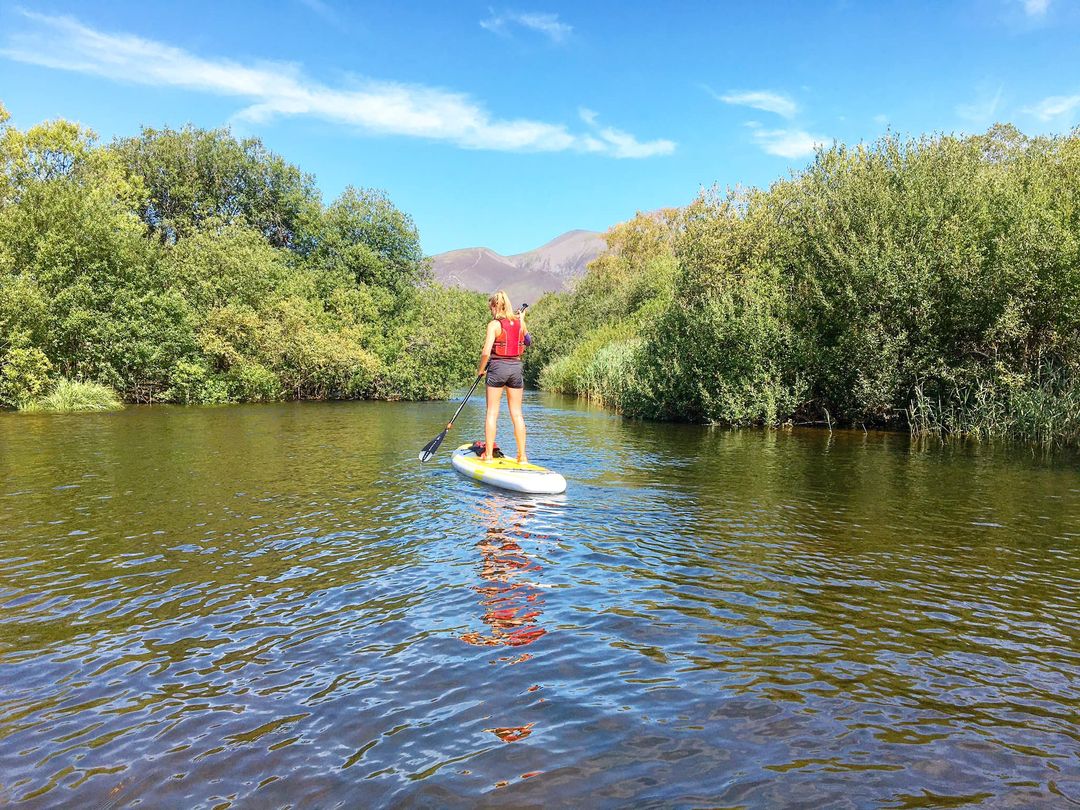 A woman paddle boarding