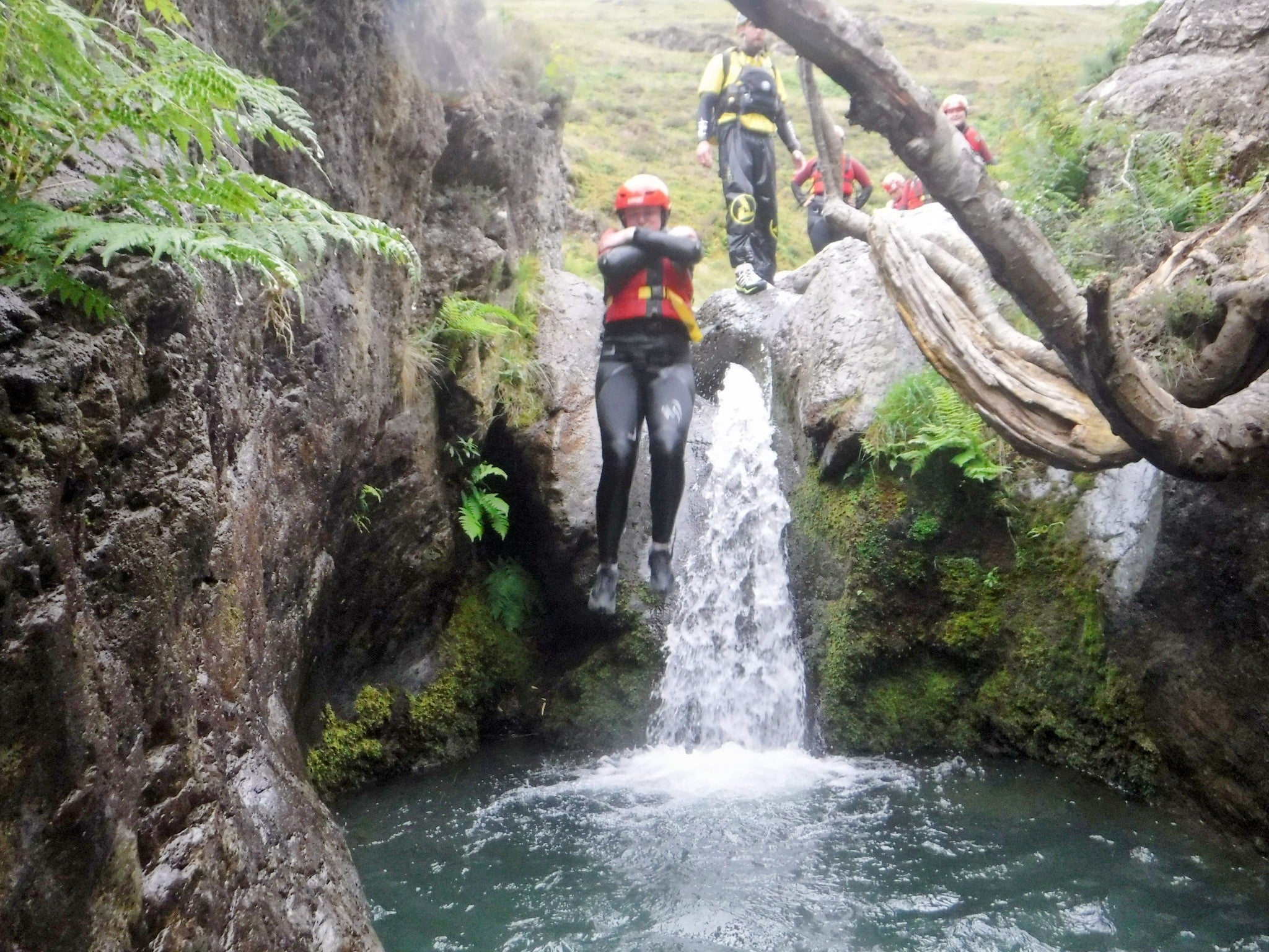 Person jumping off a waterfall in the Lake District