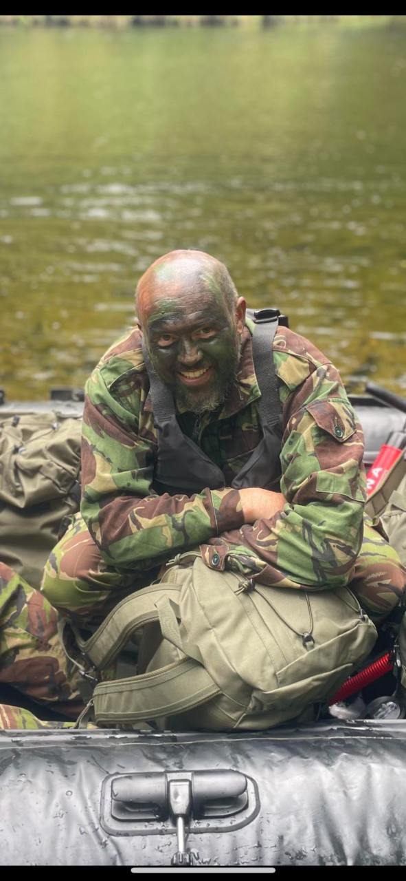 Man in camouflage by the river