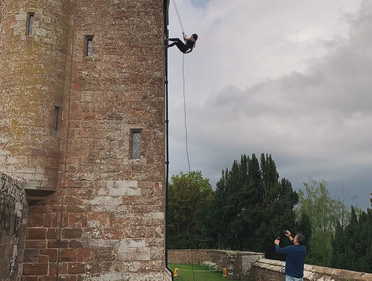 Person abseiling down Rose Castle